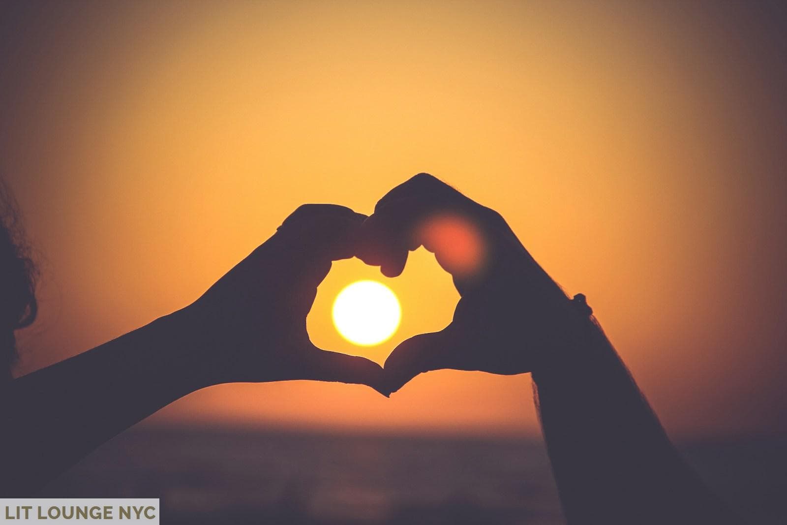 silhouette of person's hands forming heart