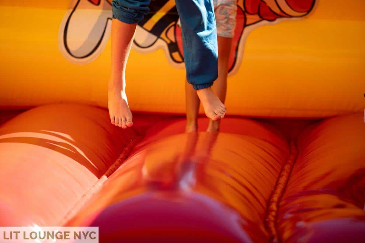 A young boy jumping on a bouncy castle